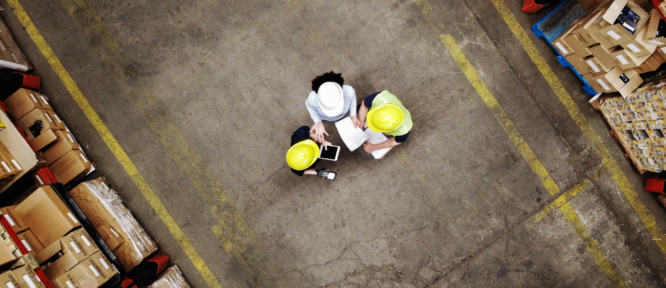 Supervisor discussing with employees at warehouse