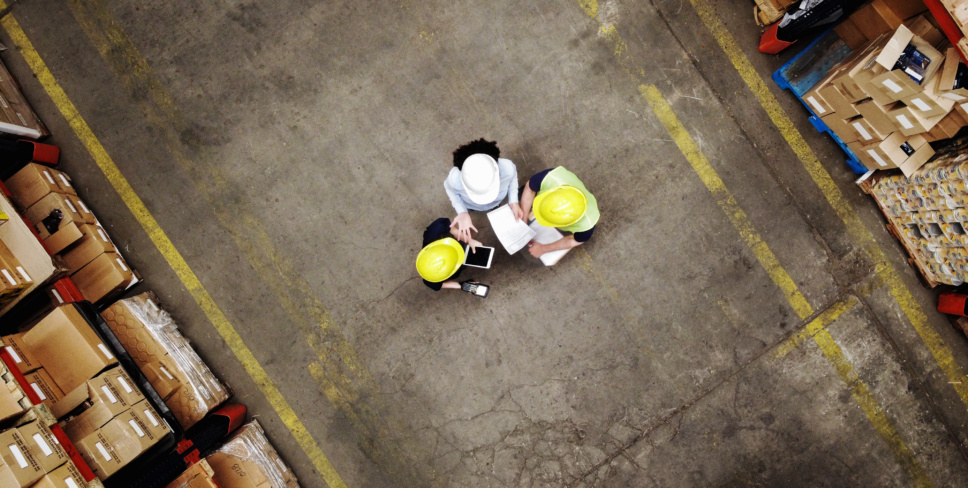 Supervisor discussing with employees at warehouse